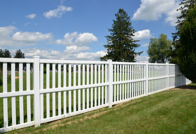 Picture of a white vinyl fence separating two properties